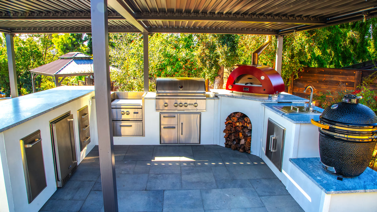 white u shaped outdoor kitchen with pizza oven