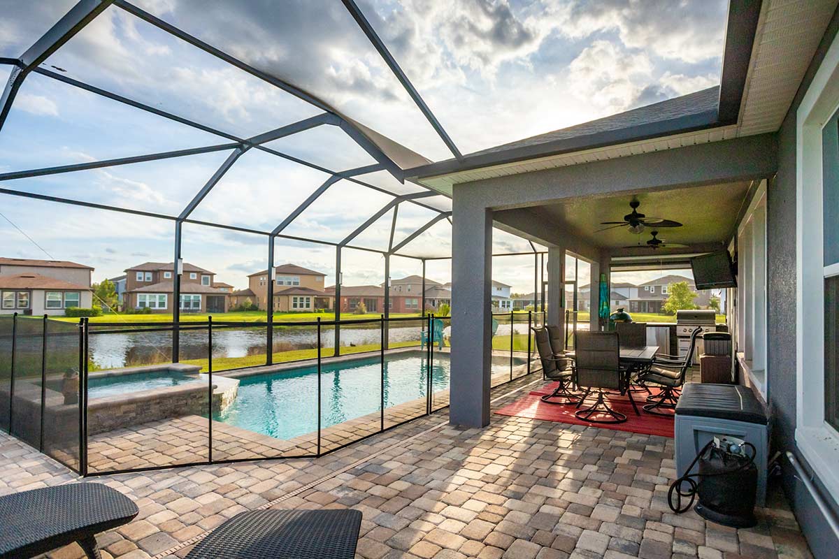 wide shot of florida room and patio next to pool