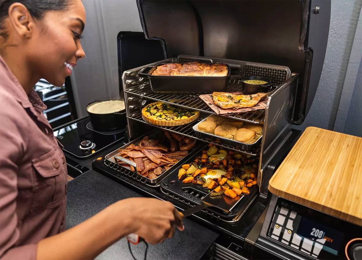 woman using a traeger timberline