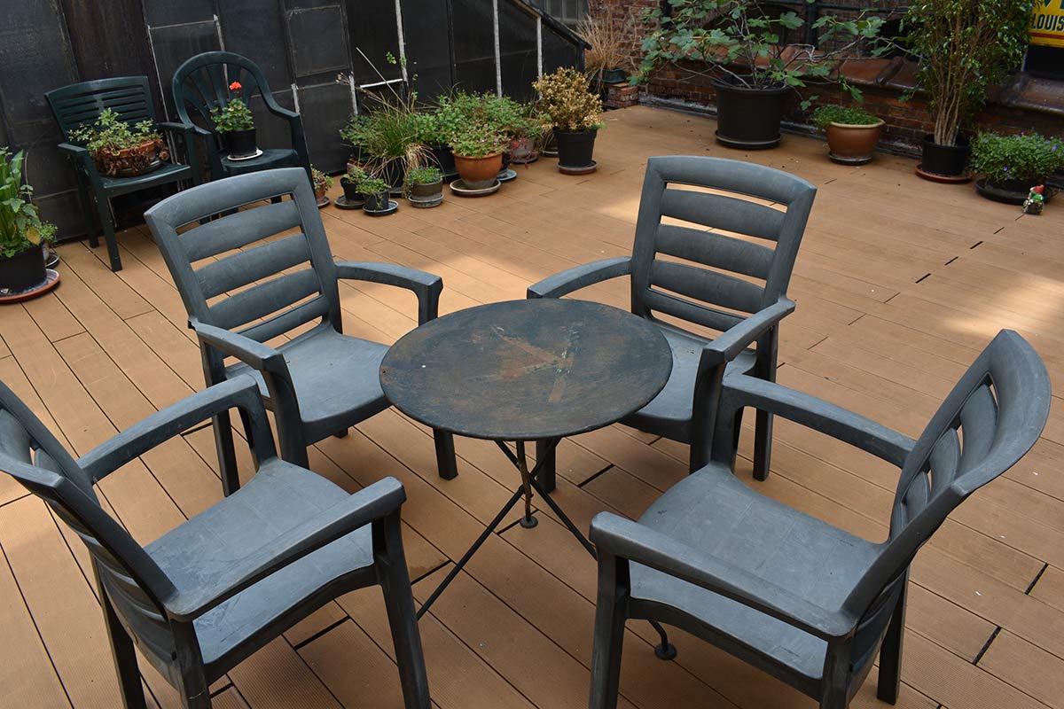 worn patio furniture on a deck