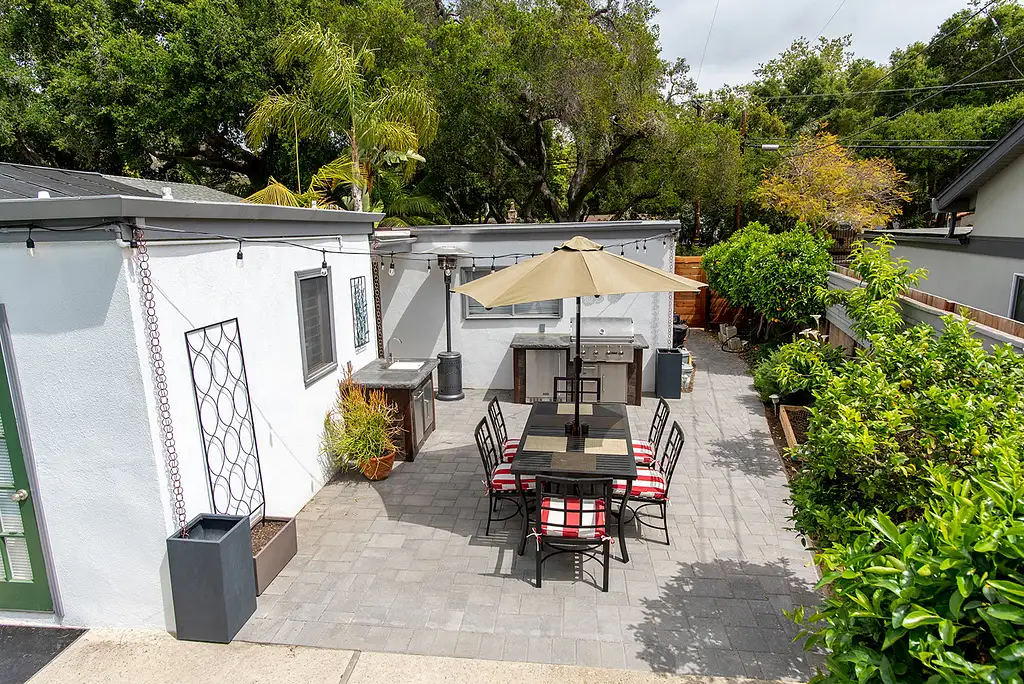 small outdoor kitchen setup on patio with built in grill and sink